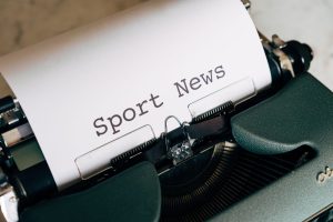 Close-up of a vintage typewriter with 'Sport News' typed on paper, evoking retro charm. — Comment Cryptoleo Casino innove pou