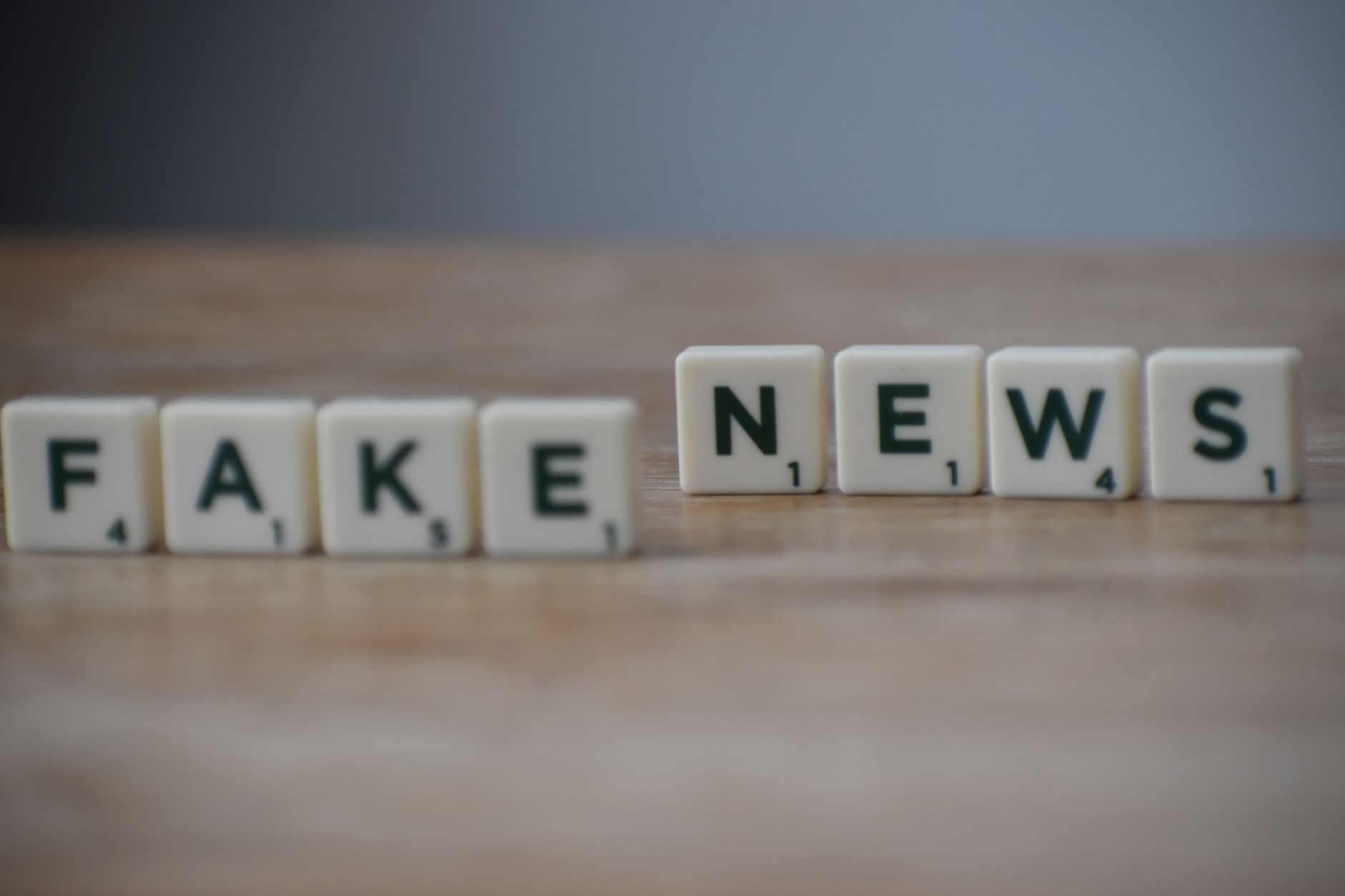 Scrabble tiles spelling 'Fake News' on a wooden surface highlighting misinformation. — Sensible Medical insurance Preparation